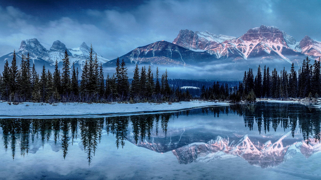 1366 X 768 Winter Lake By Forest And Mountain Background