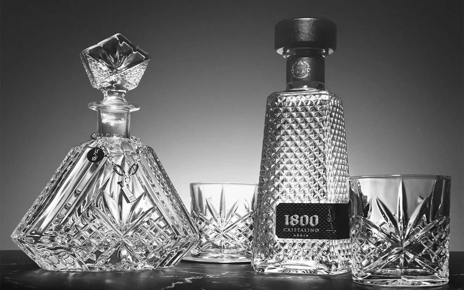 1800 Tequila Cristalino Anejo With Crystal Decanter Background