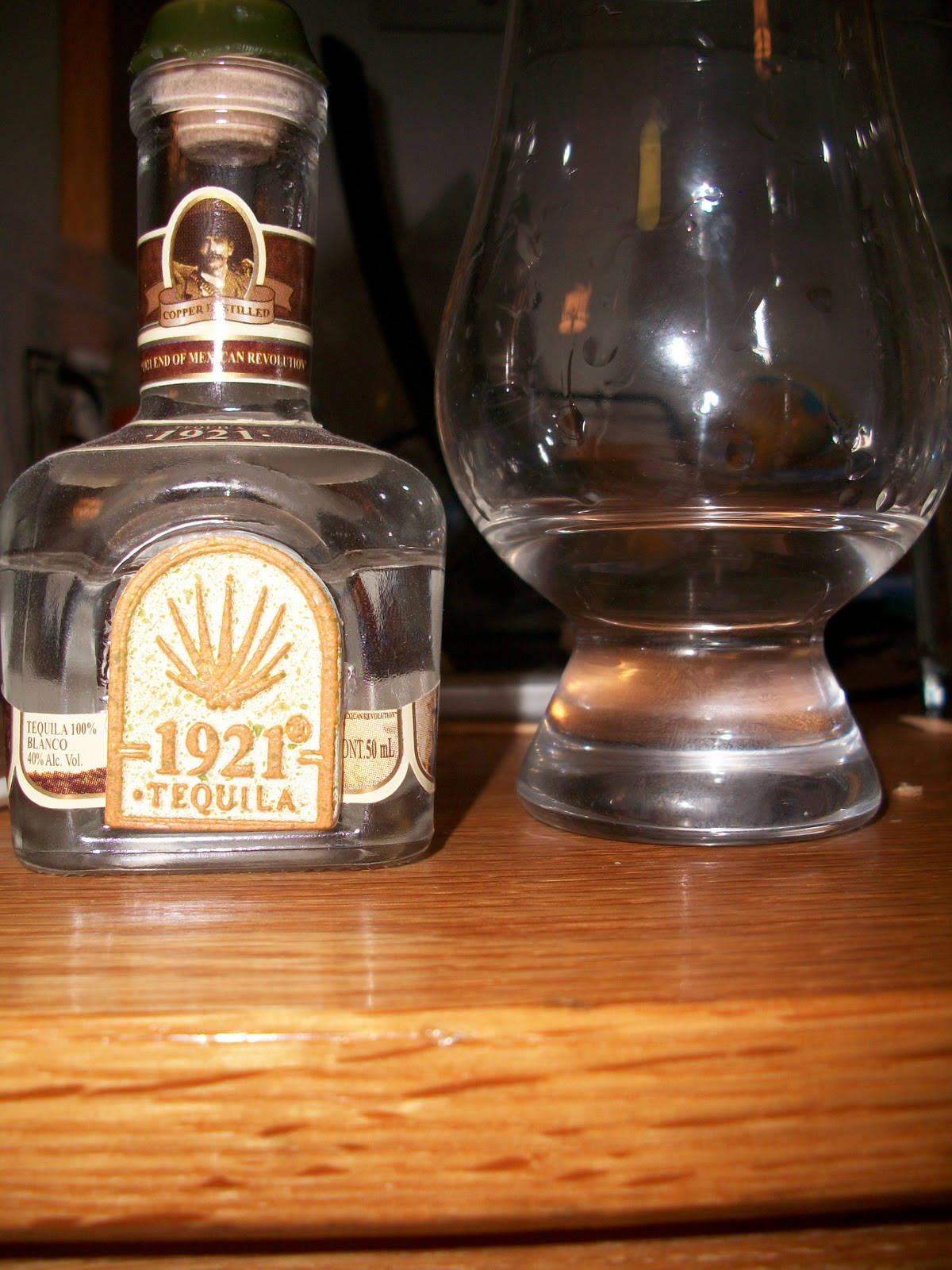 1921 Reposado Tequila With Glass Background