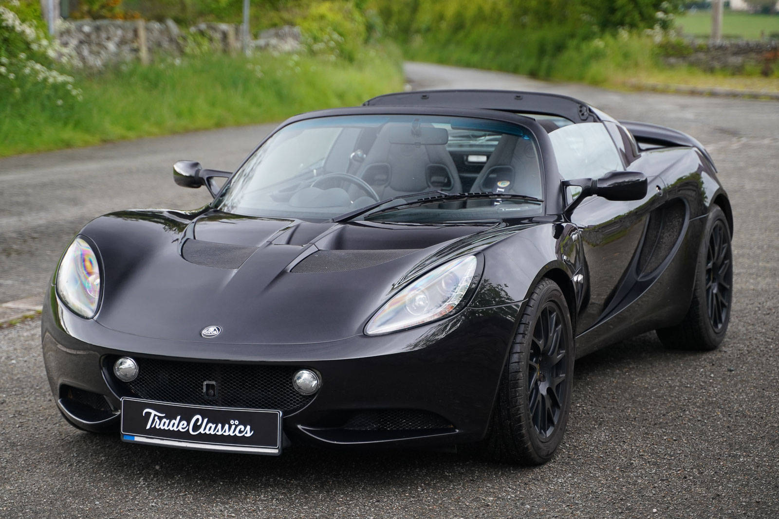 2013 Shiny Black Lotus Elise Convertible Car Background