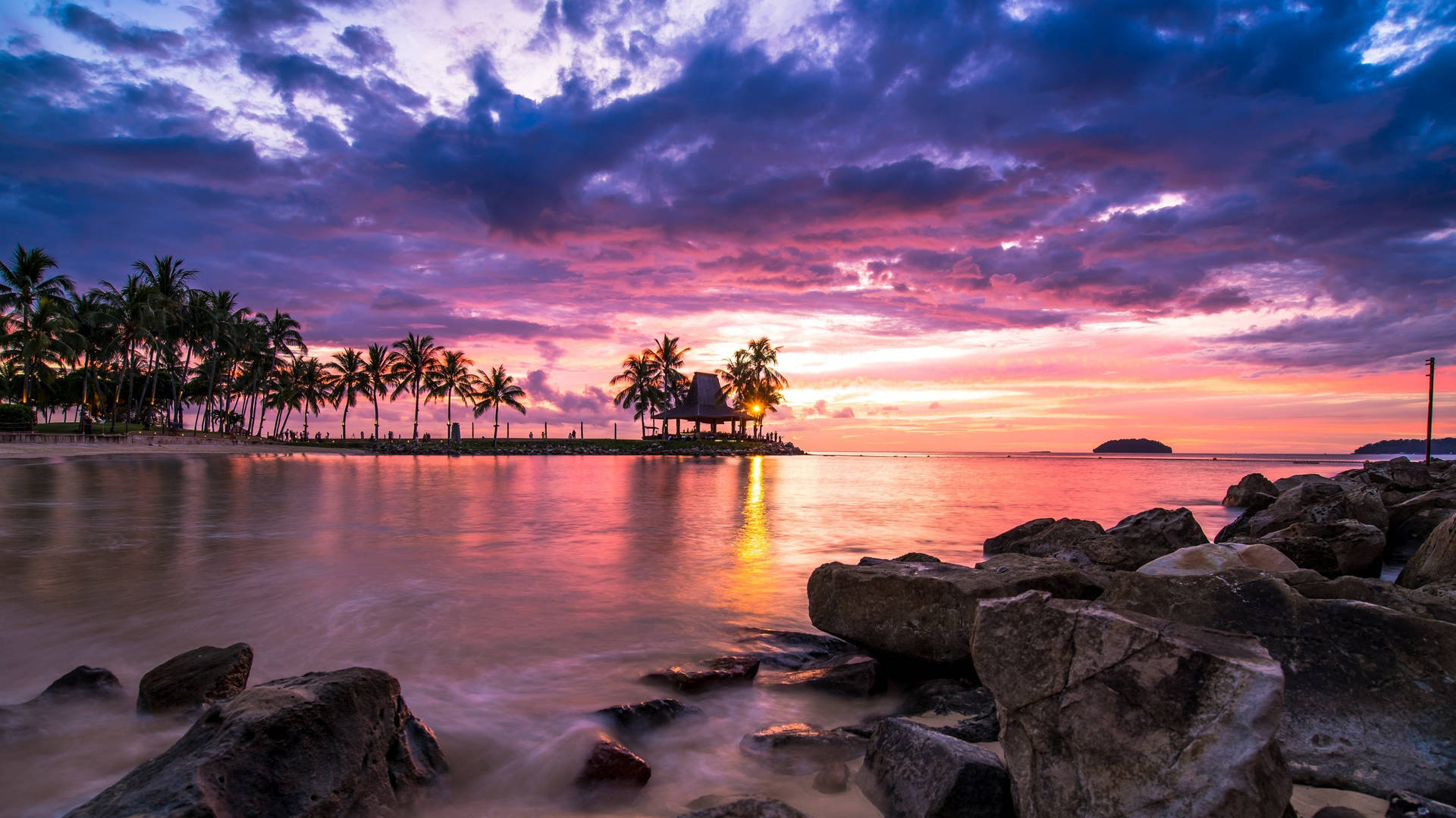 2560 X 1440 Sunset By Rocky Seaside Background