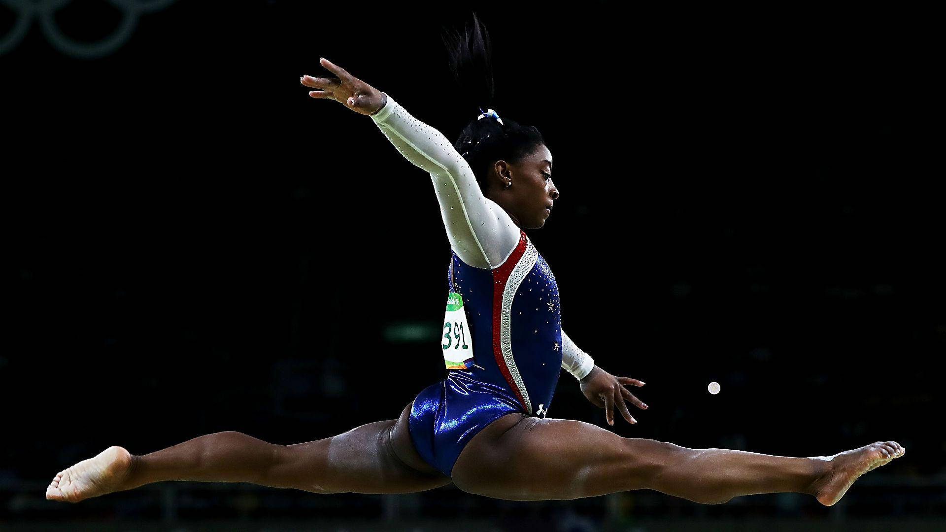 4-time Olympic Gold Medalist Simone Biles Performs On The Balance Beam Background