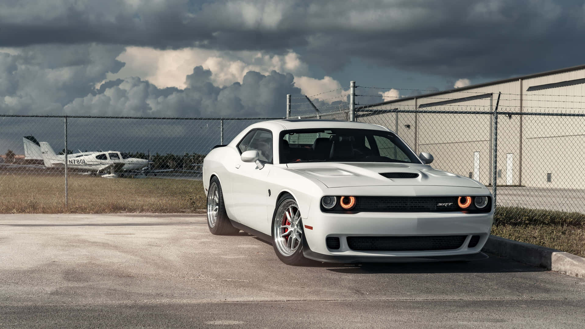 4k Dodge Hellcat Parked At A Hangar Background