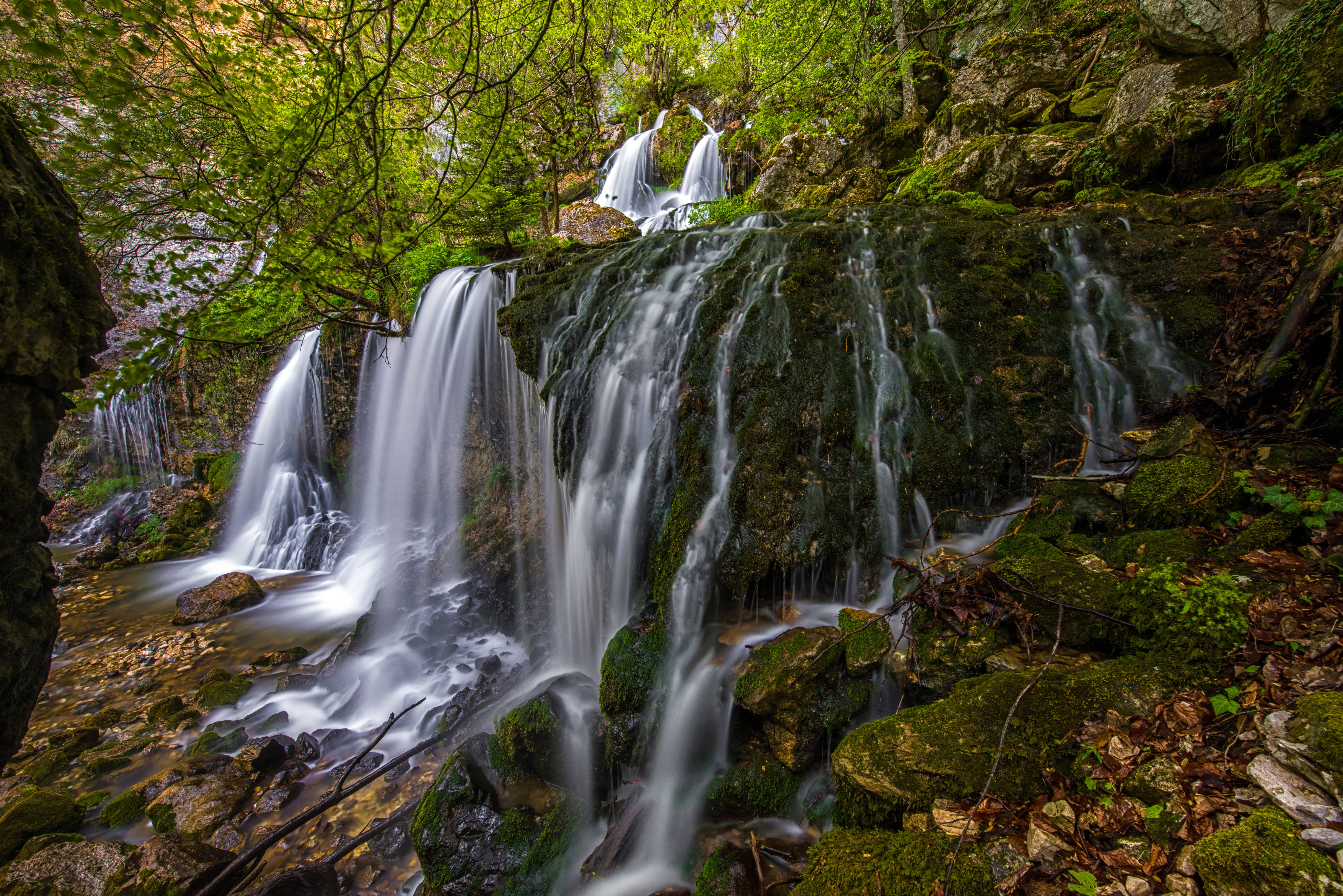4k Green Cascade De La Doriaz Waterfall Background