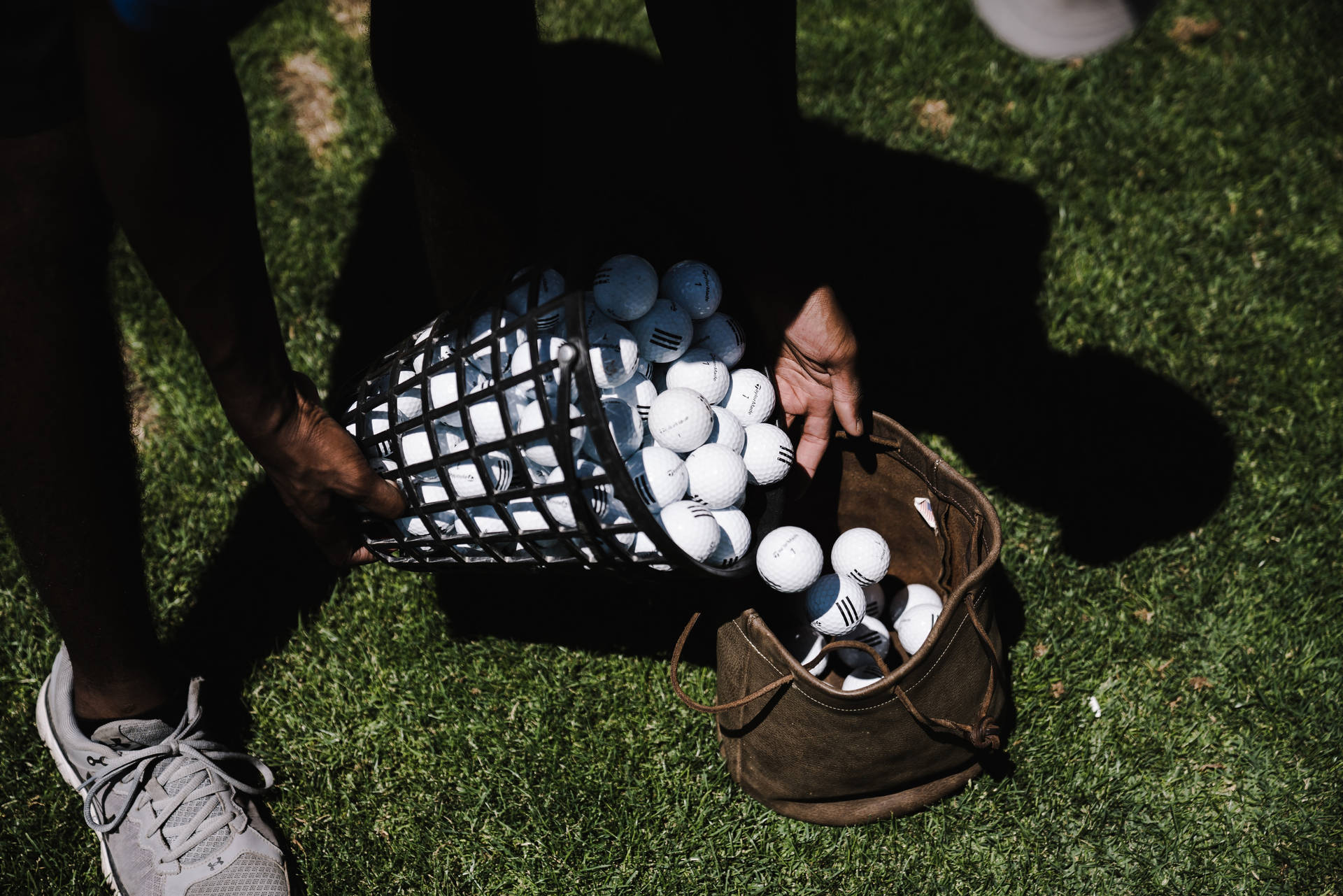 4k Person Pushing Golf Balls Towards Bag Background