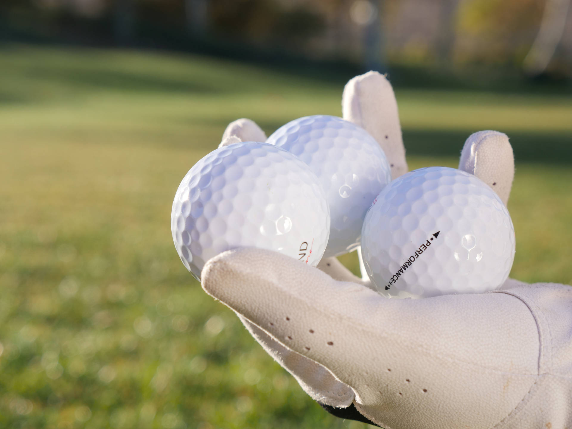 4k Three White Golf Balls On Hand Background