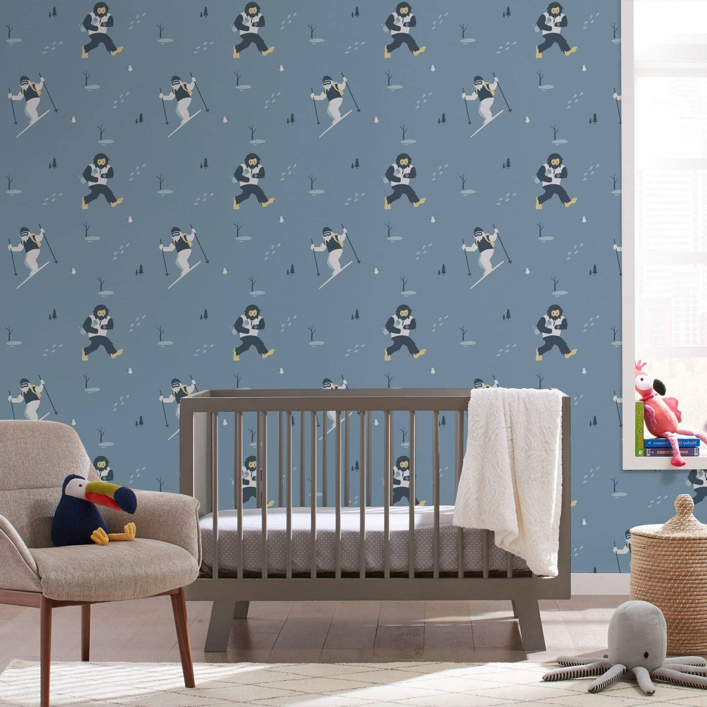 A Baby's Room With A Blue Wall And A Crib