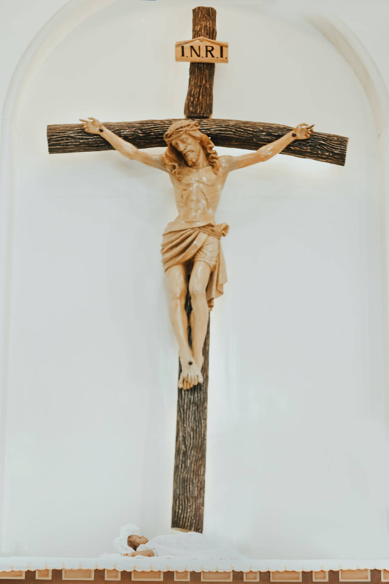A Baby Underneath Jesus On Cross