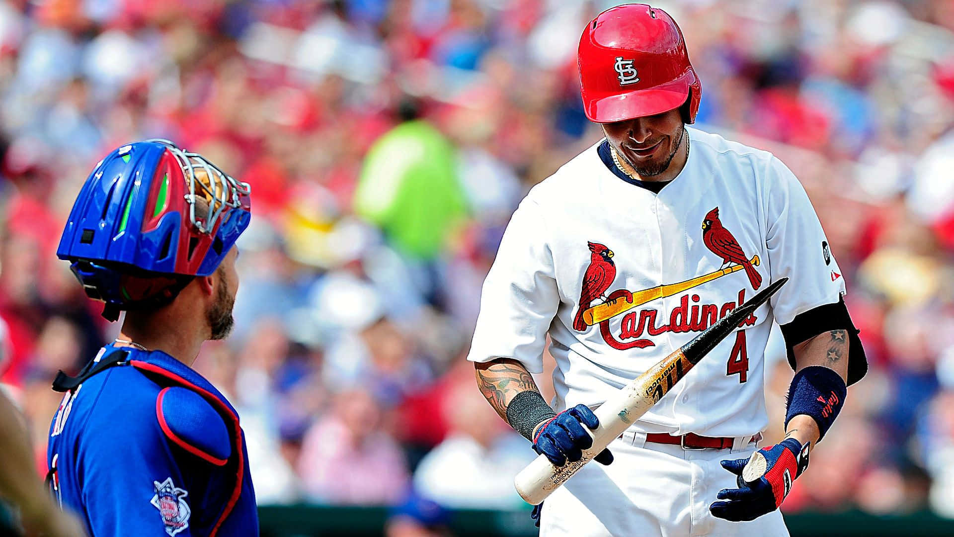 A Baseball Player Is Holding A Bat Background