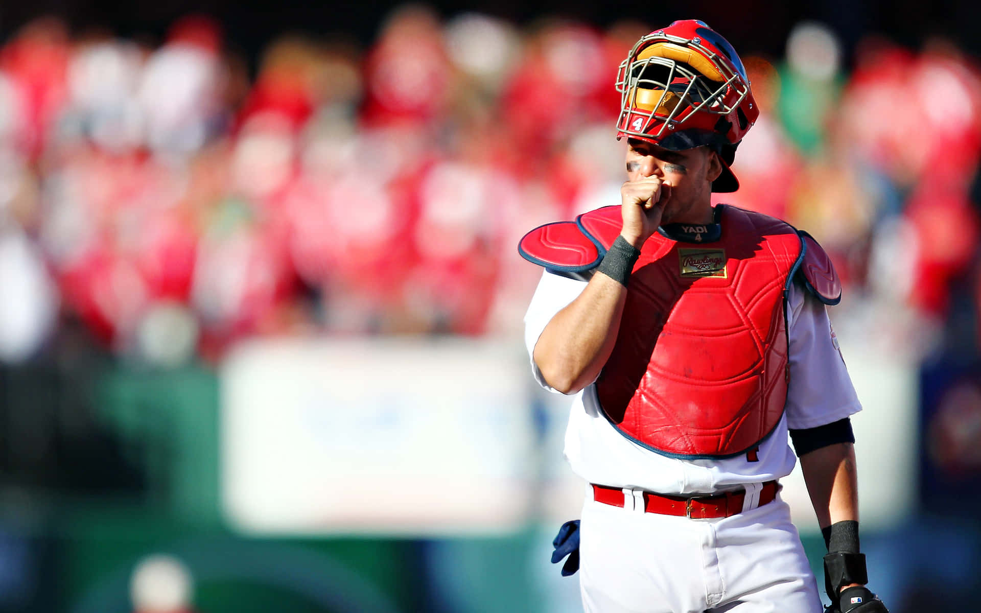 A Baseball Player Is Holding His Glove And Looking At The Ground Background