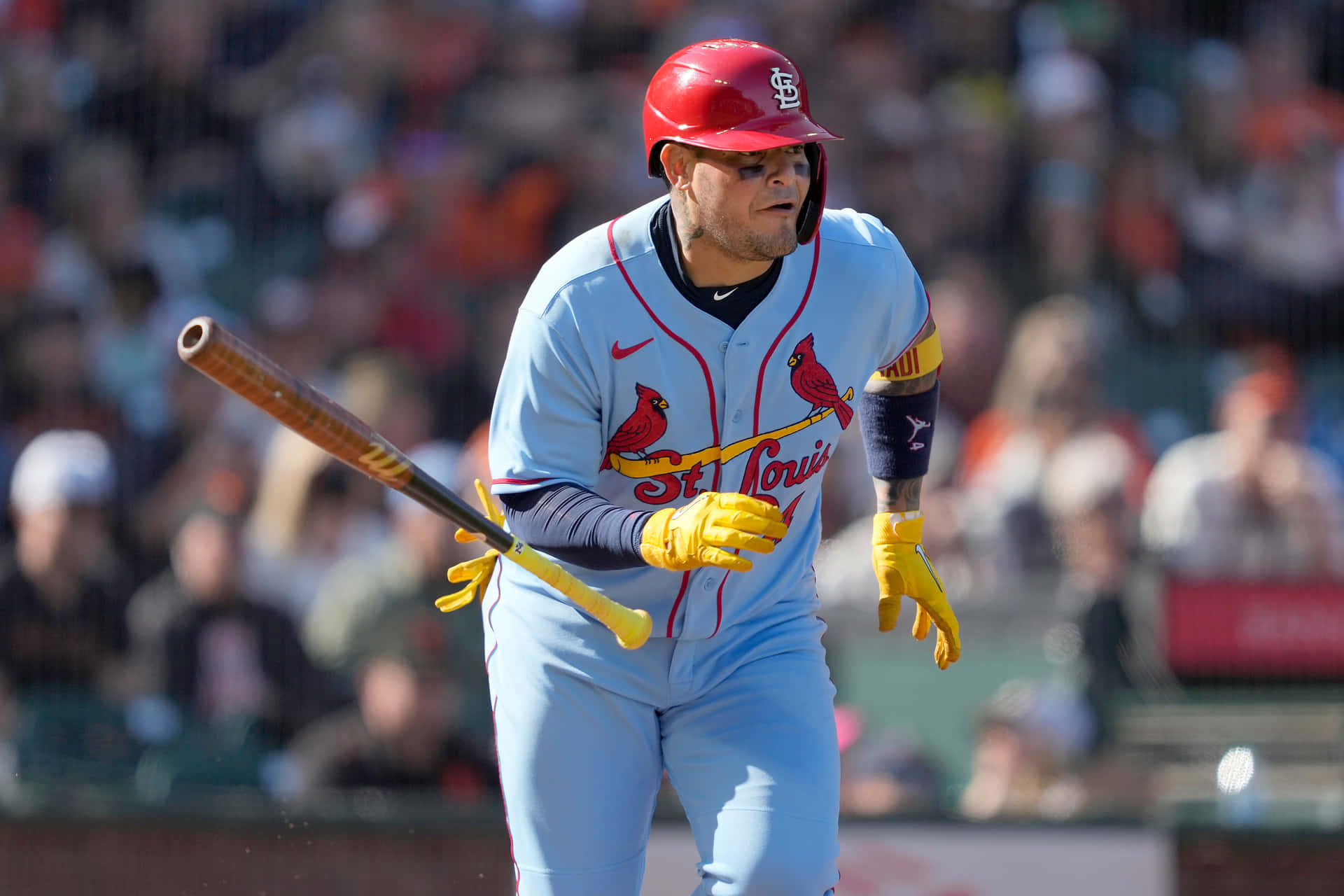 A Baseball Player Is Running With A Bat Background