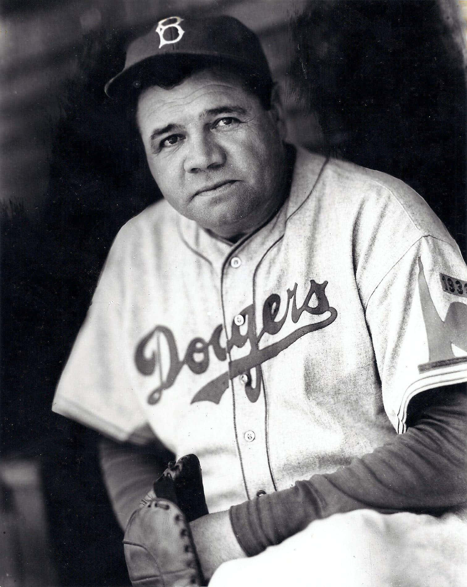 A Baseball Player Is Sitting In A Baseball Uniform Background