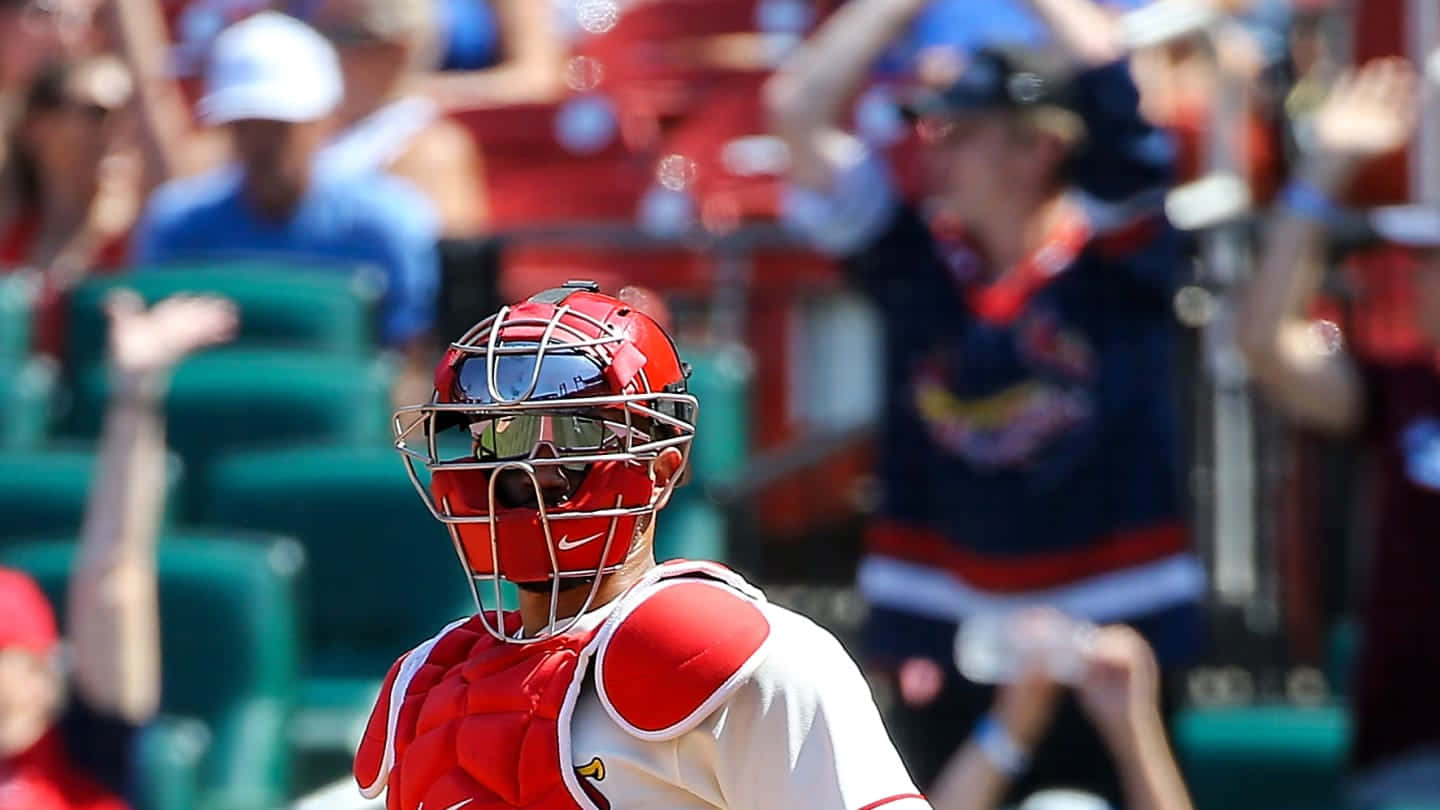 A Baseball Player Is Standing In Front Of A Crowd Background