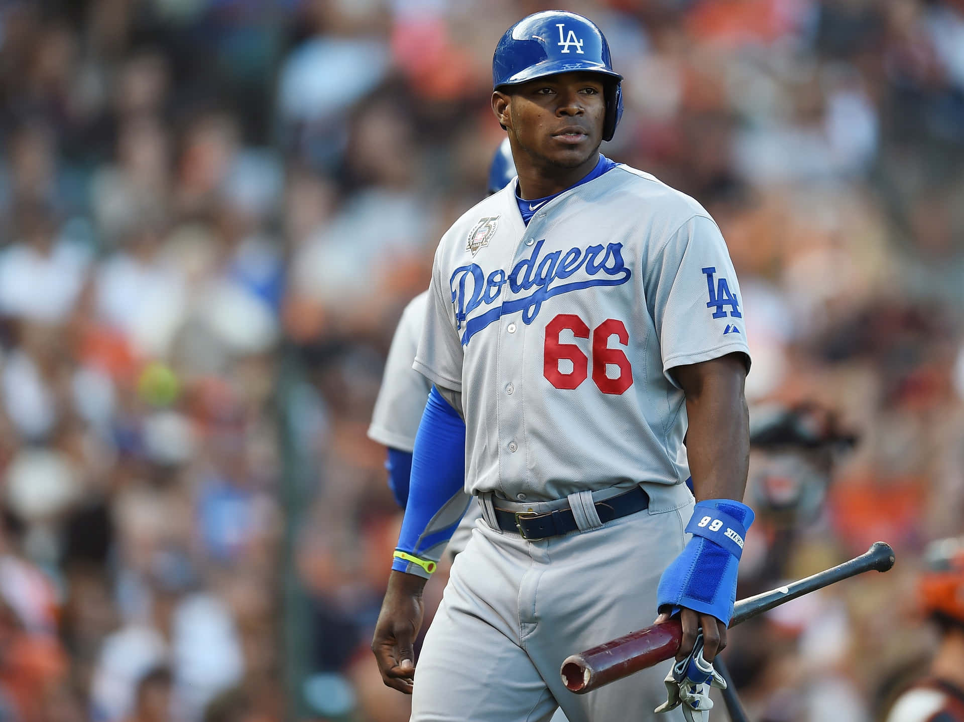 A Baseball Player Is Walking On A Field