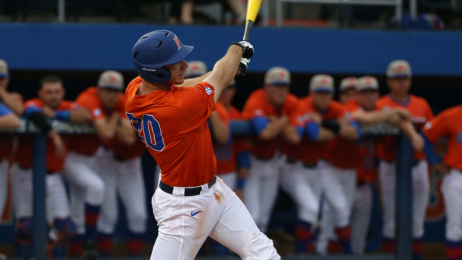 A Baseball Player Swinging A Bat Background