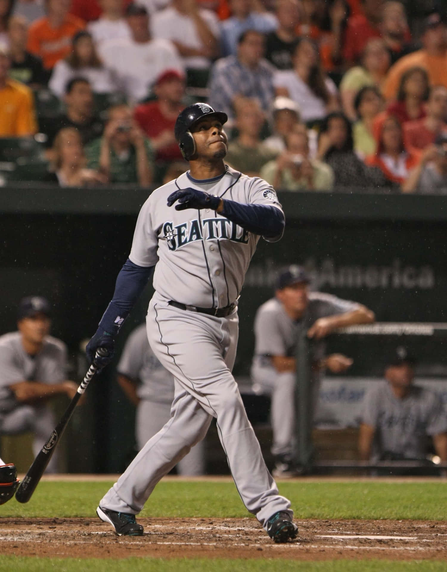 A Baseball Player Swinging A Bat Background