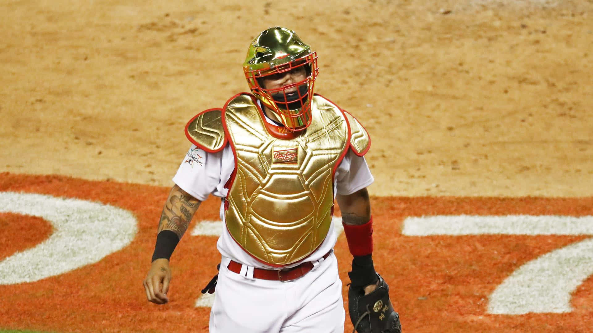 A Baseball Player Wearing A Gold Catchers Mask Background