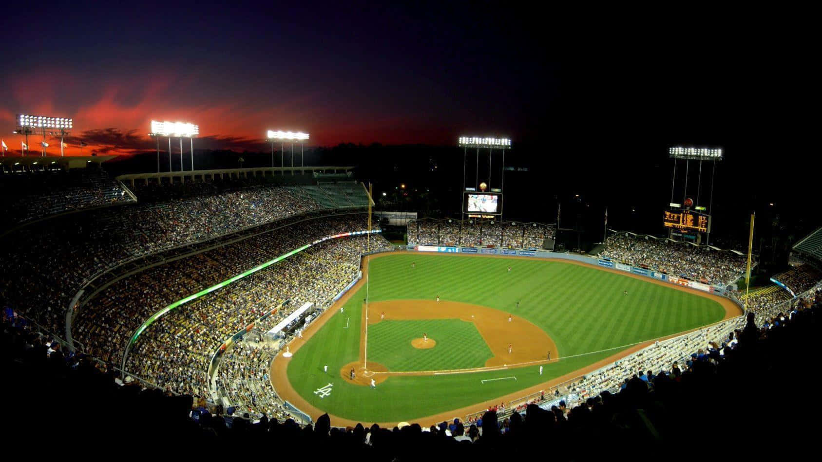 A Baseball Stadium At Night With Lights On