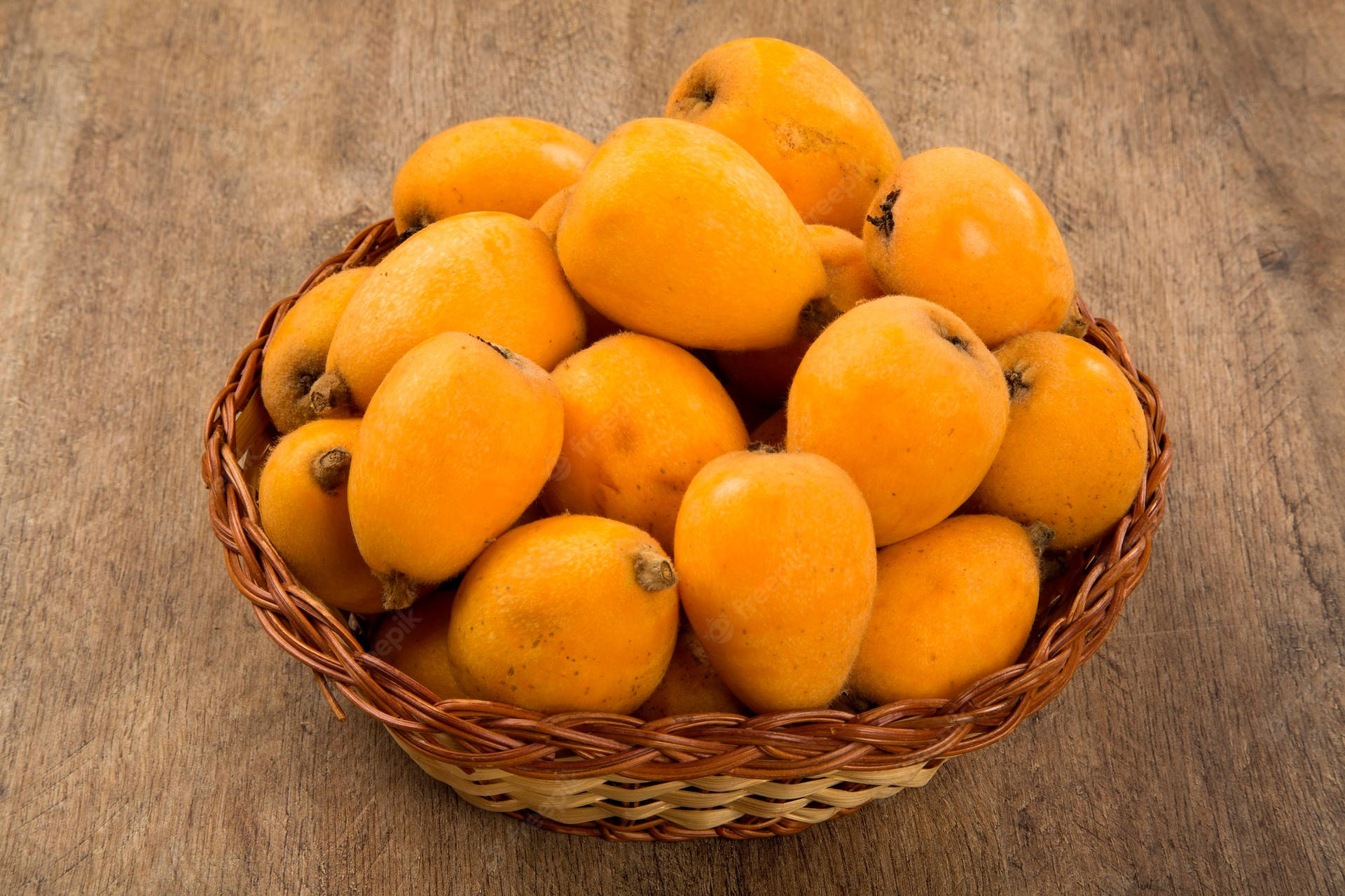 A Basket Full Of Fresh Loquat Oranges Background