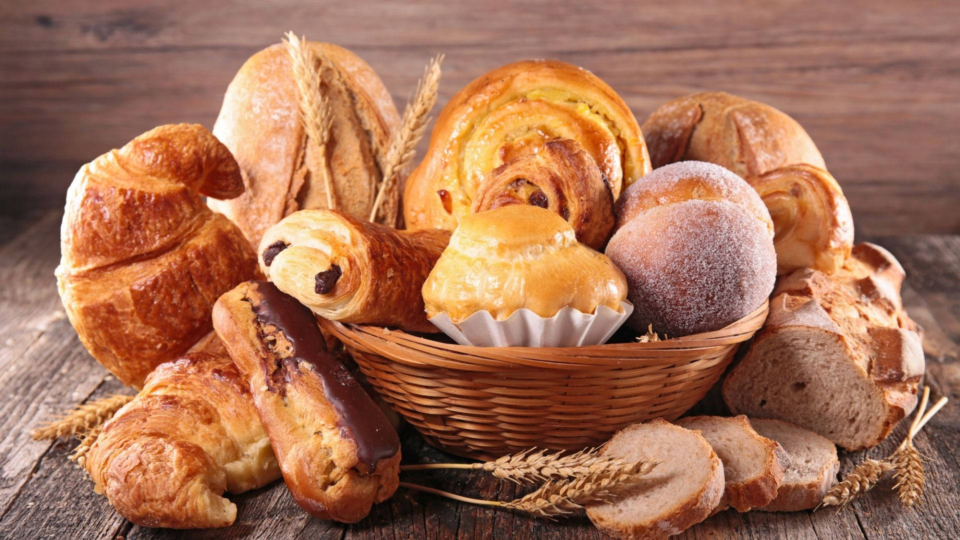 A Basket Overloaded With Artisan Breads Background