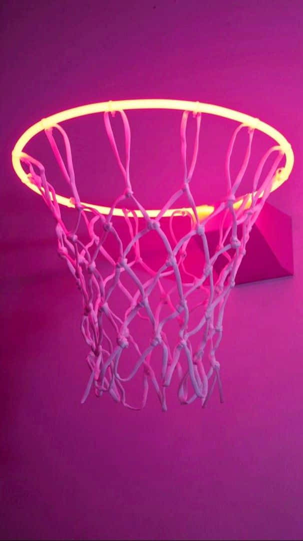 A Basketball Hoop With A Pink Light On It Background