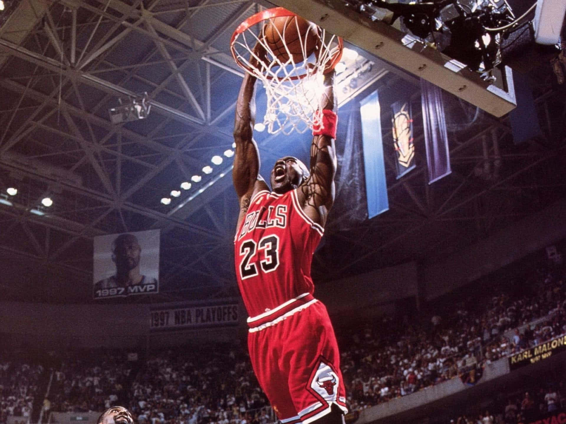 A Basketball Player Dunking The Ball In The Air Background