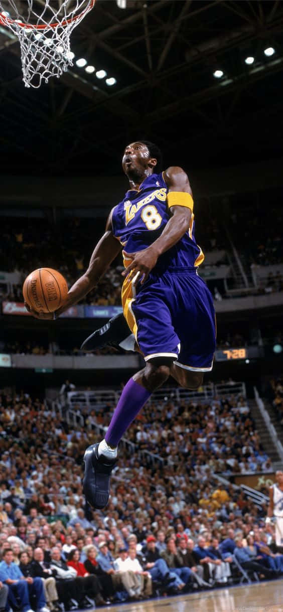 A Basketball Player In The Air Dunks The Ball Background