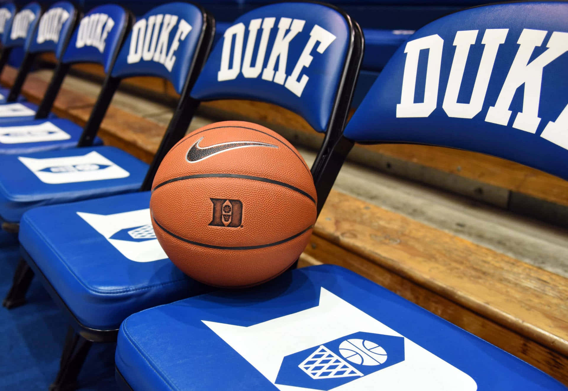 A Basketball Sits On A Blue Chair With The Word Duke Background