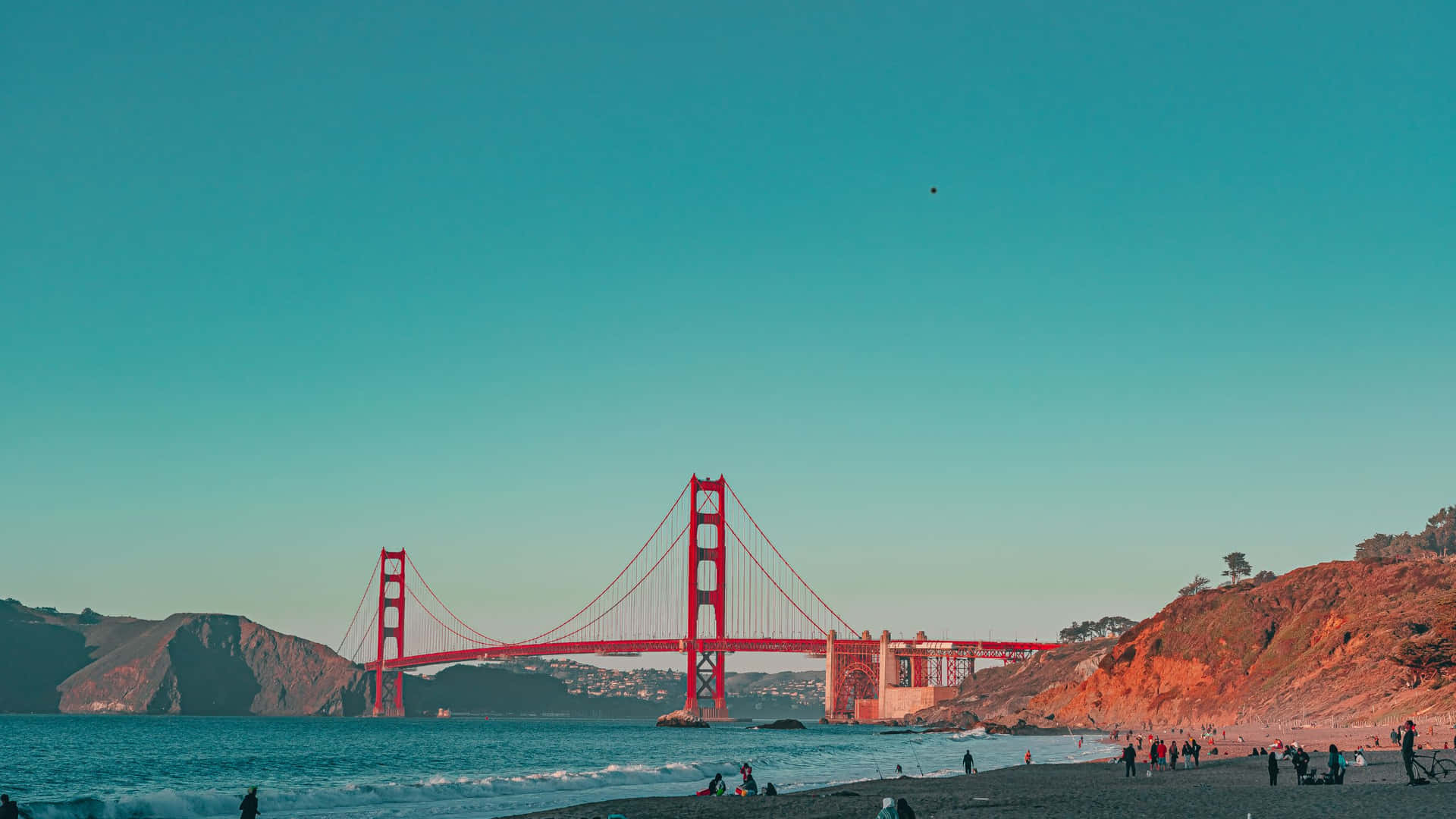 A Beach With A Golden Gate Bridge Background