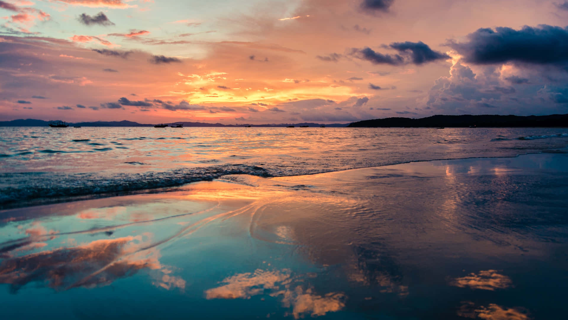 A Beach With A Sunset Background
