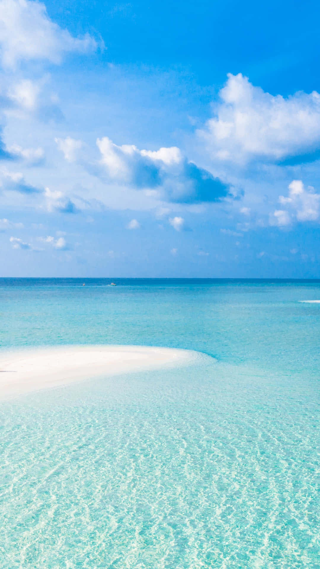 A Beach With A White Sand And Clear Water Background