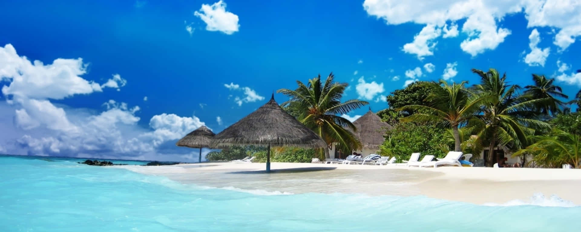 A Beach With Chairs And Umbrellas On The Water Background