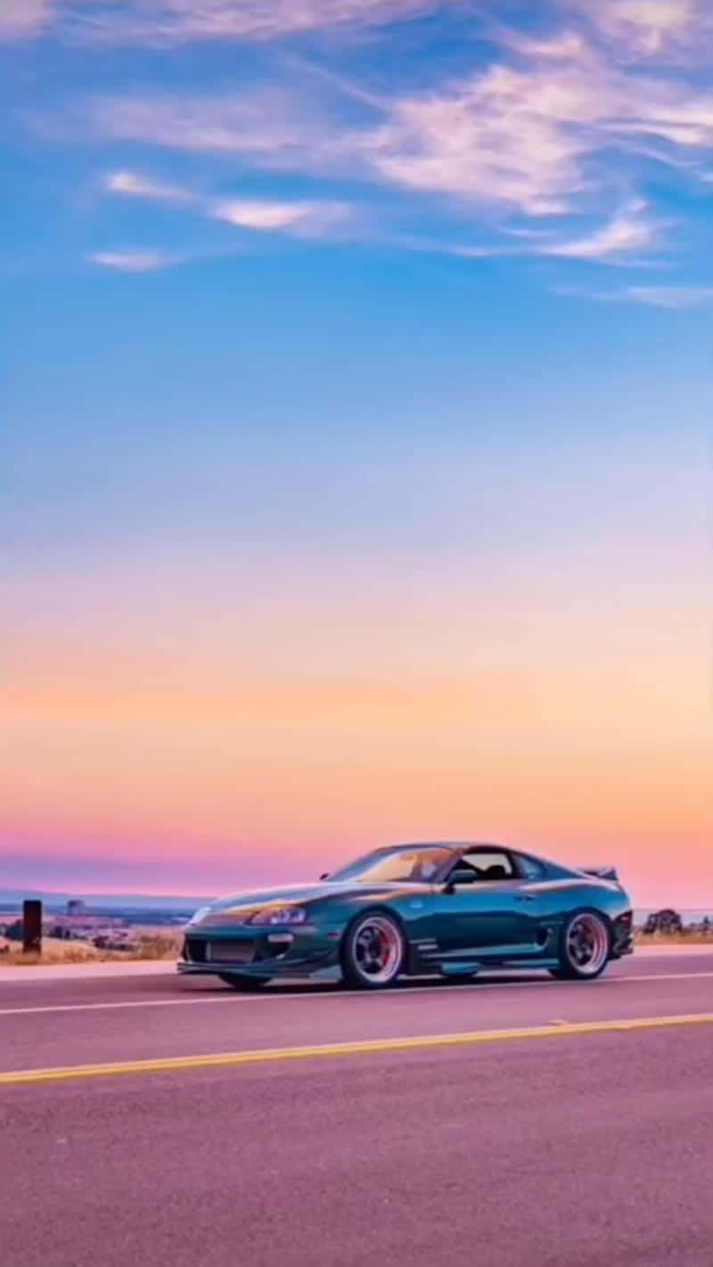 A Beautiful Blue Sports Car On A Clear Day.