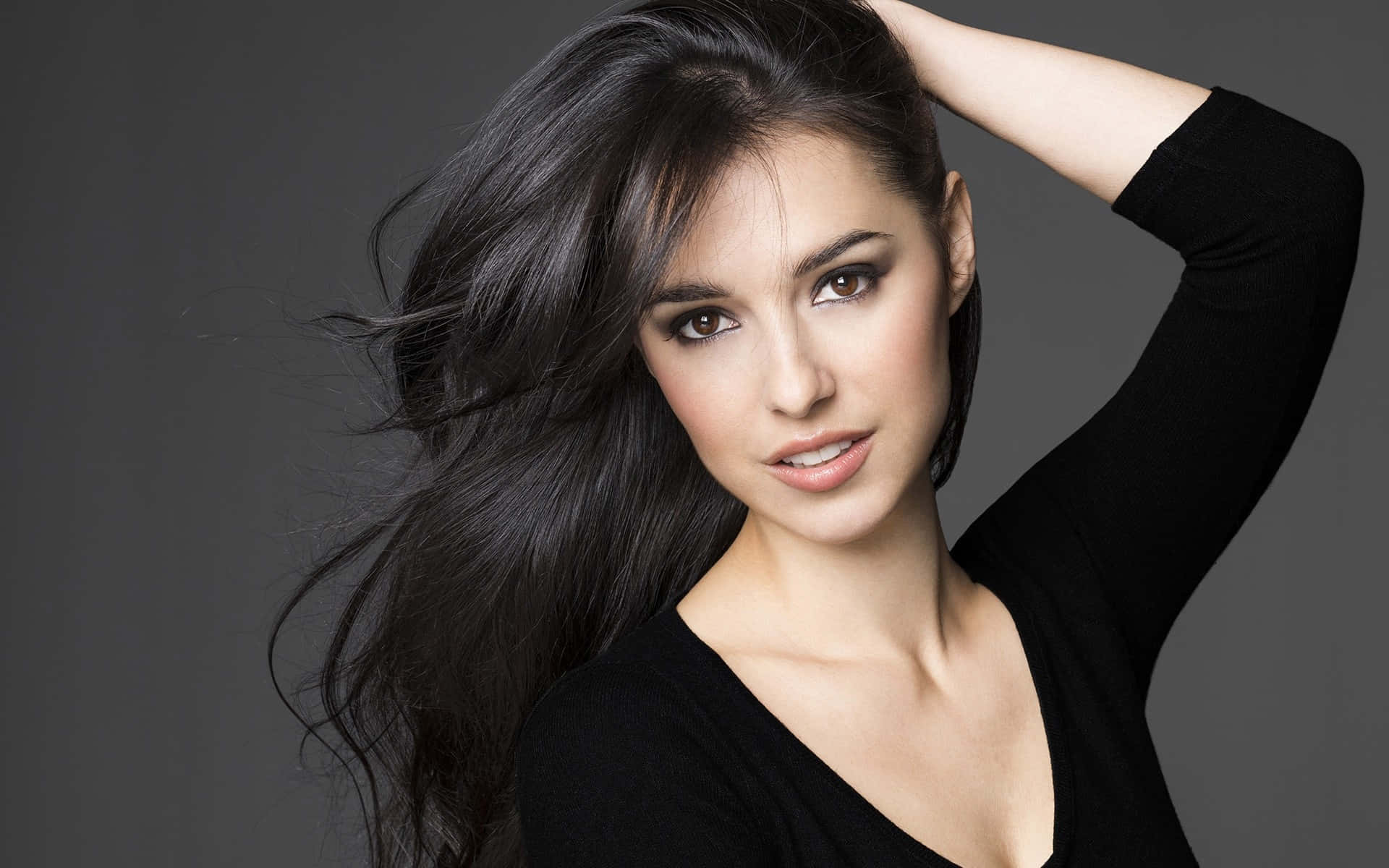 A Beautiful Girl In Blue Dress With Her Hair Blowing Freely In The Breeze