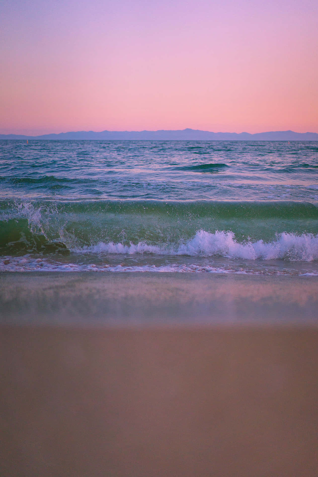 A Beautiful Pink Sunset Over The Beach Background