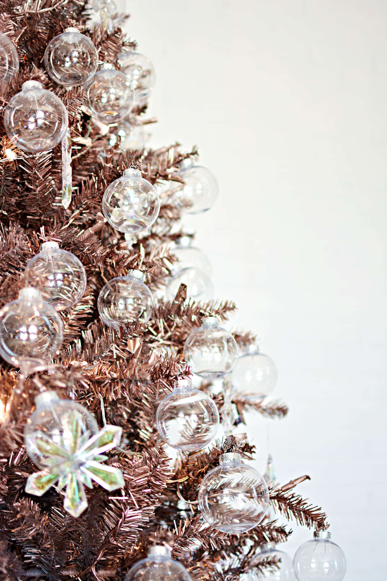 A Beautiful, Snow-covered Aesthetic Christmas Tree Standing Tall In A Winter Landscape