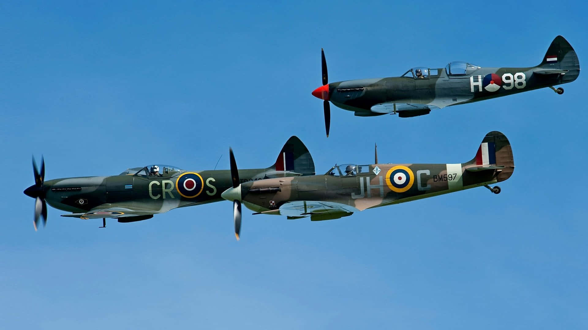 A Beautiful Spitfire Flying Through A Picturesque Sky Background
