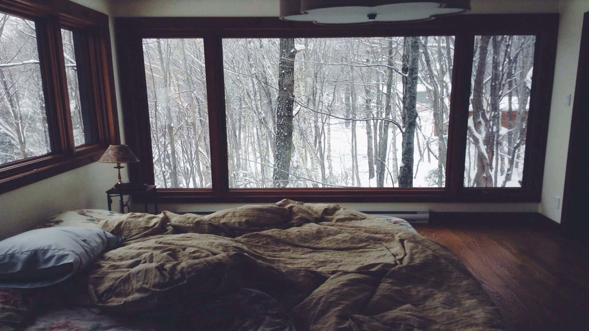 A Bed With A Blanket On It And A Window Background