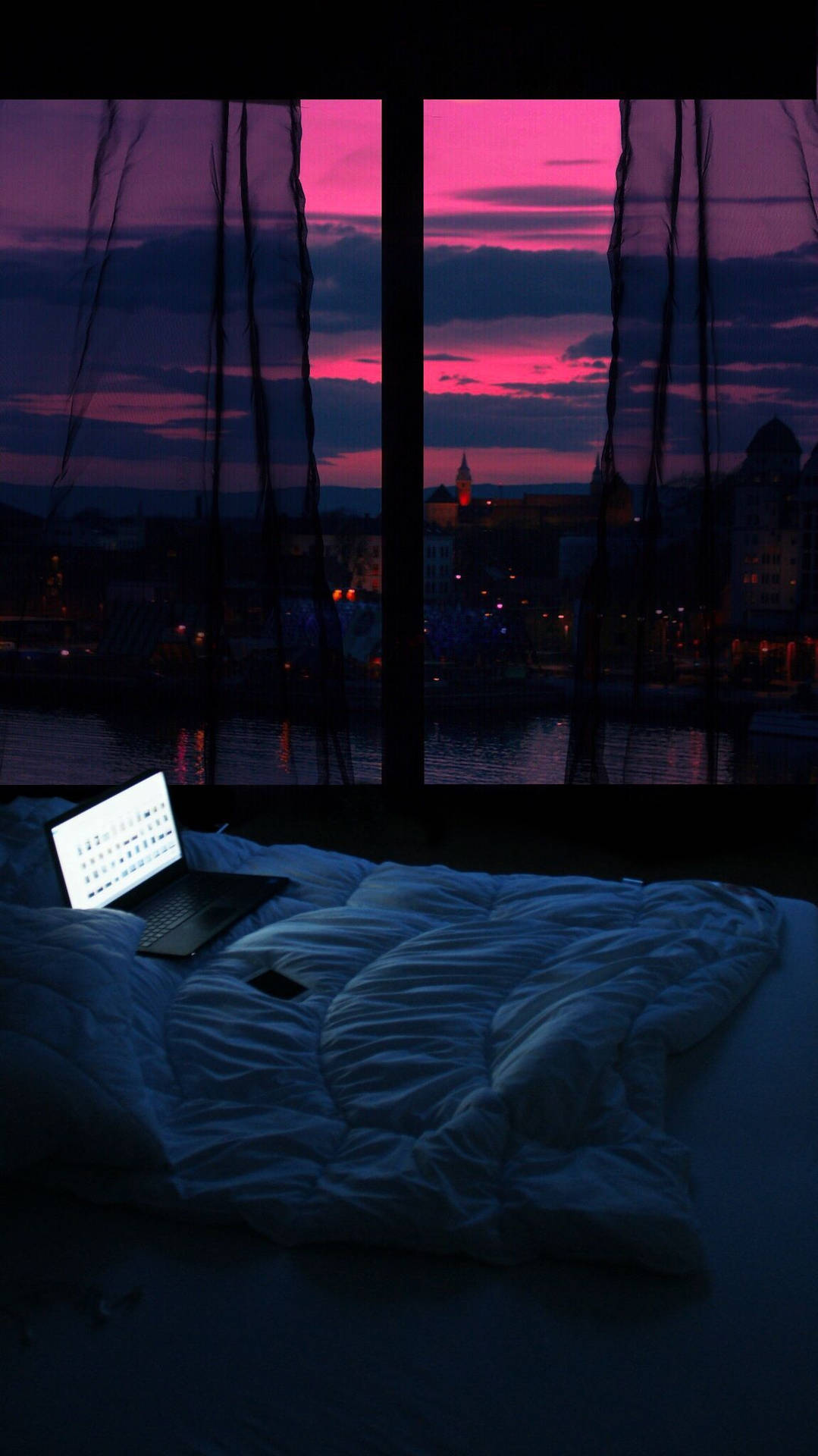 A Bed With A Laptop Background