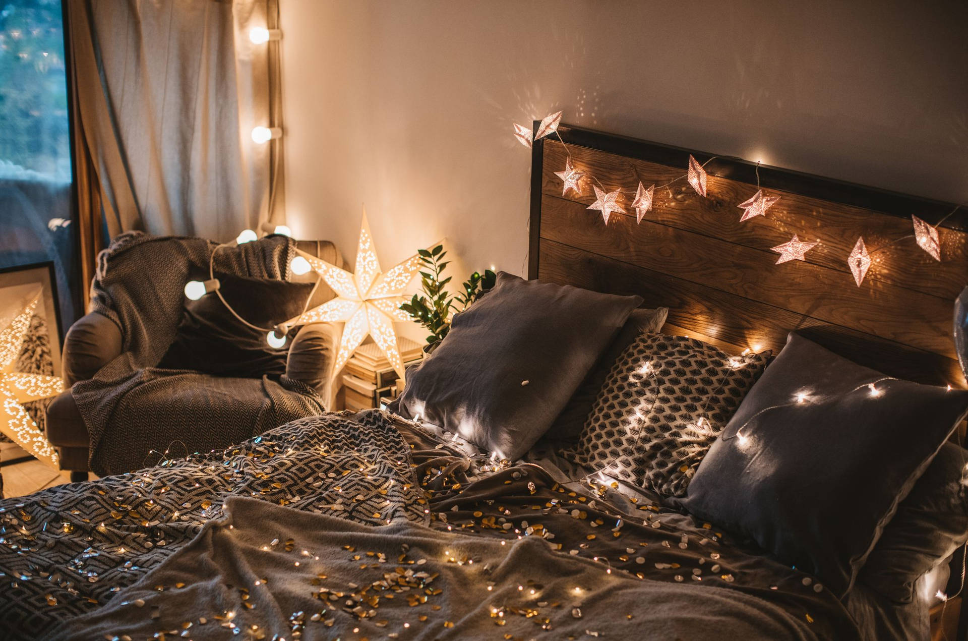 A Bed With Christmas Lights And A Lamp Background