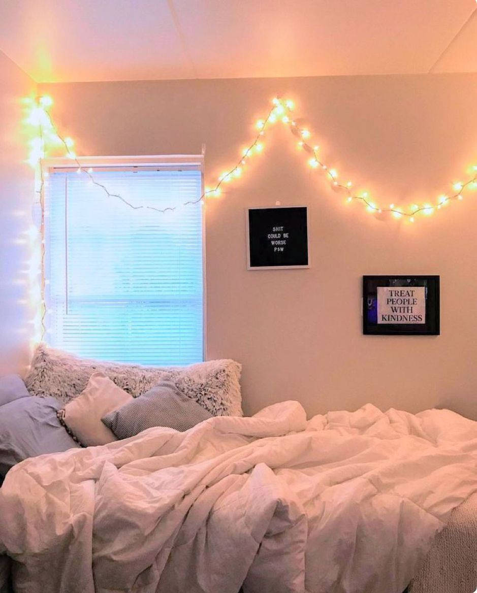 A Bed With Lights Hanging From The Ceiling