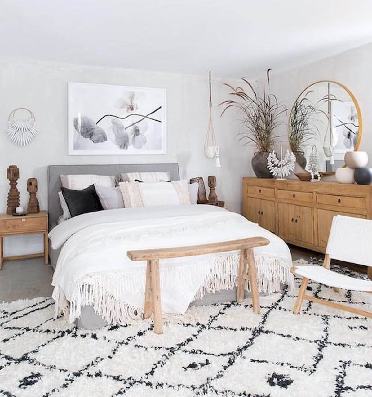 A Bedroom With A Bed, A Rug And A Mirror Background