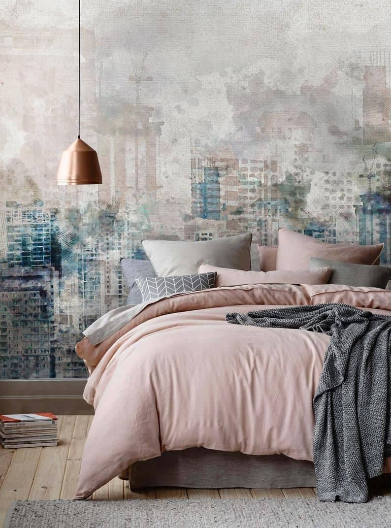 A Bedroom With A Pink Bed And A City Mural Background