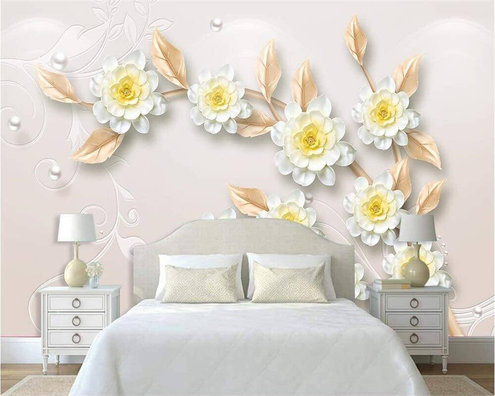 A Bedroom With A White Bed And White Flowers