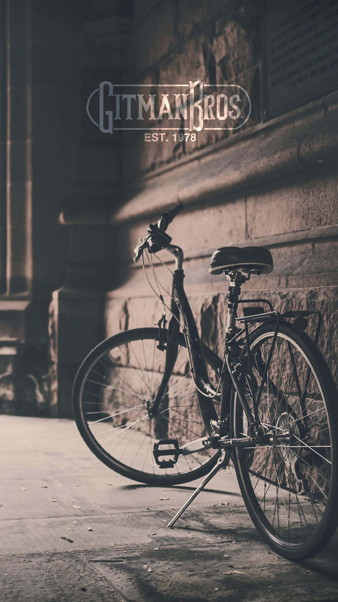 A Bike Is Leaning Against A Wall