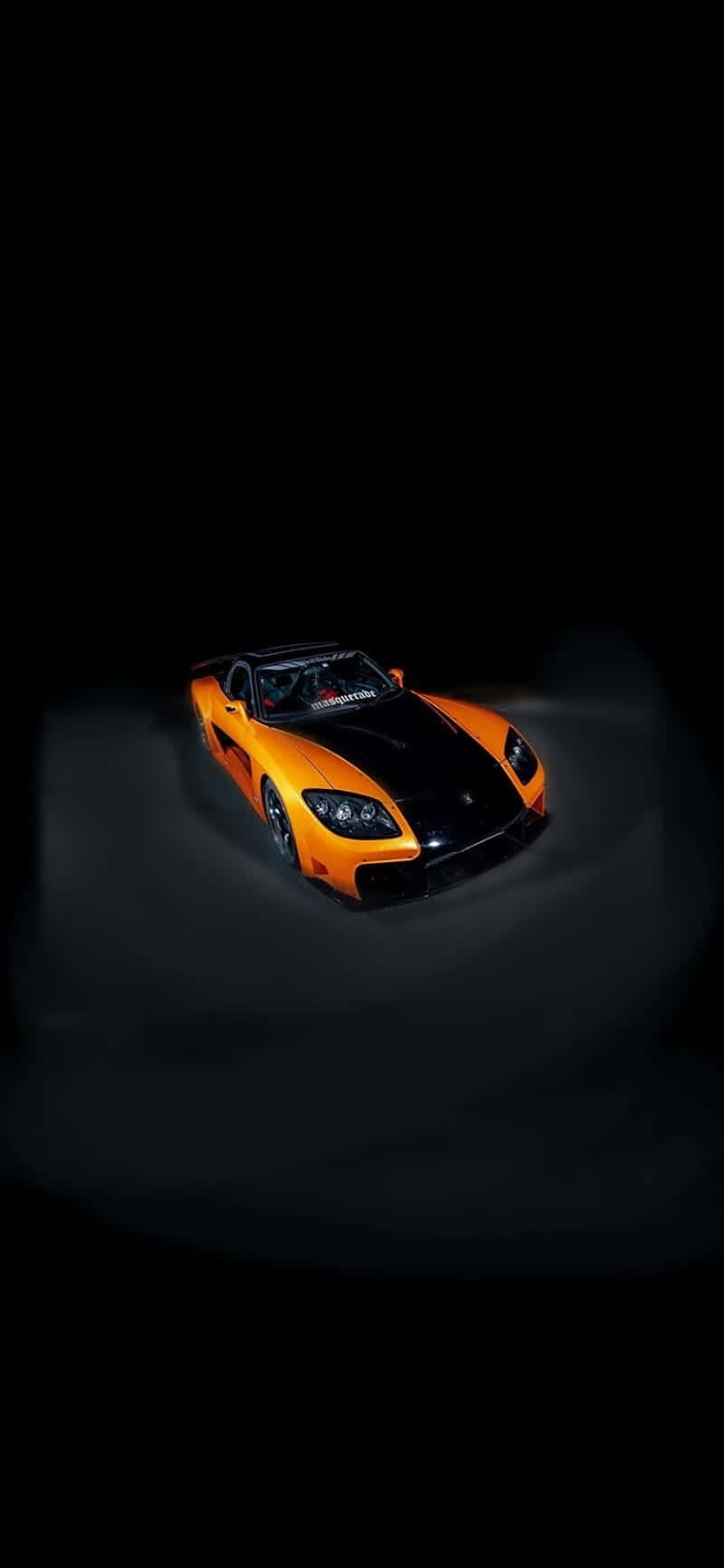 A Black And Orange Sports Car In The Dark Background