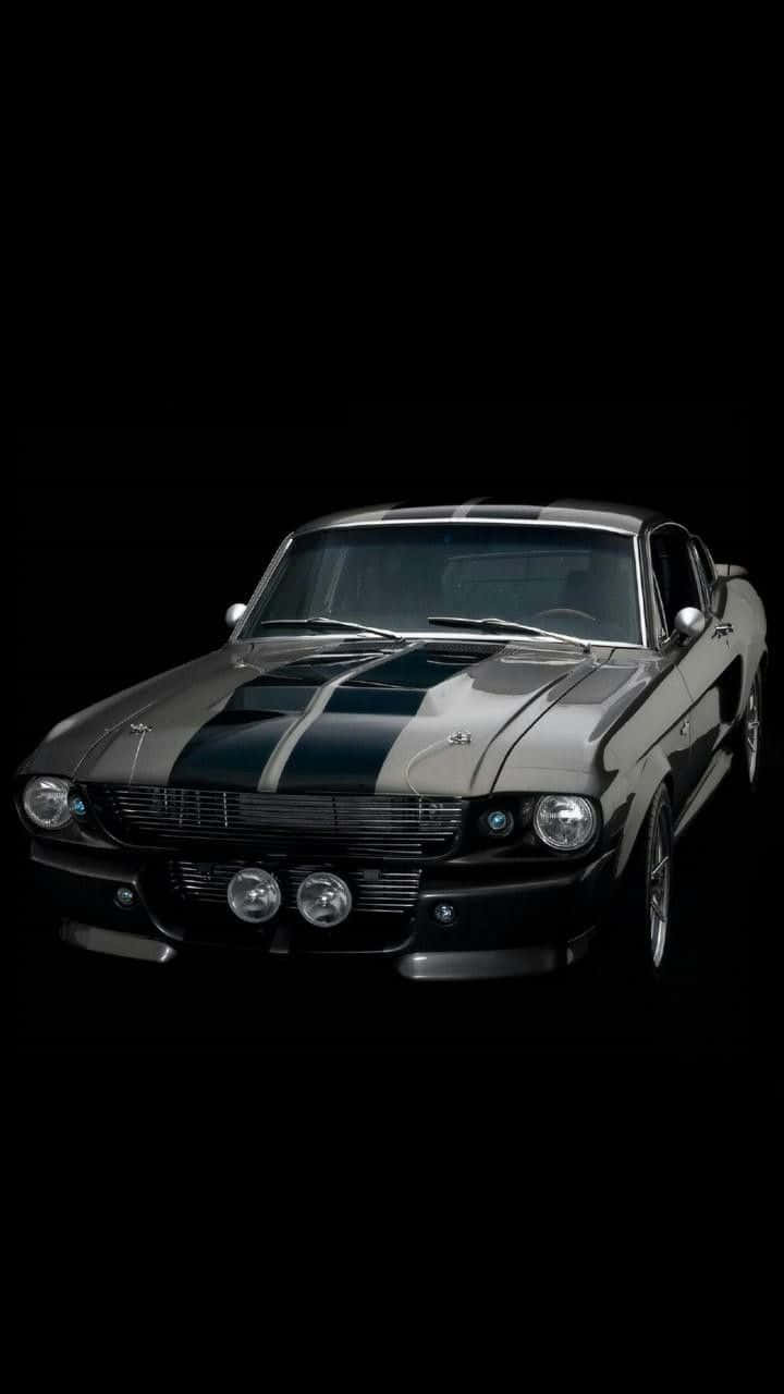 A Black And Silver Mustang Is Shown In The Background Background