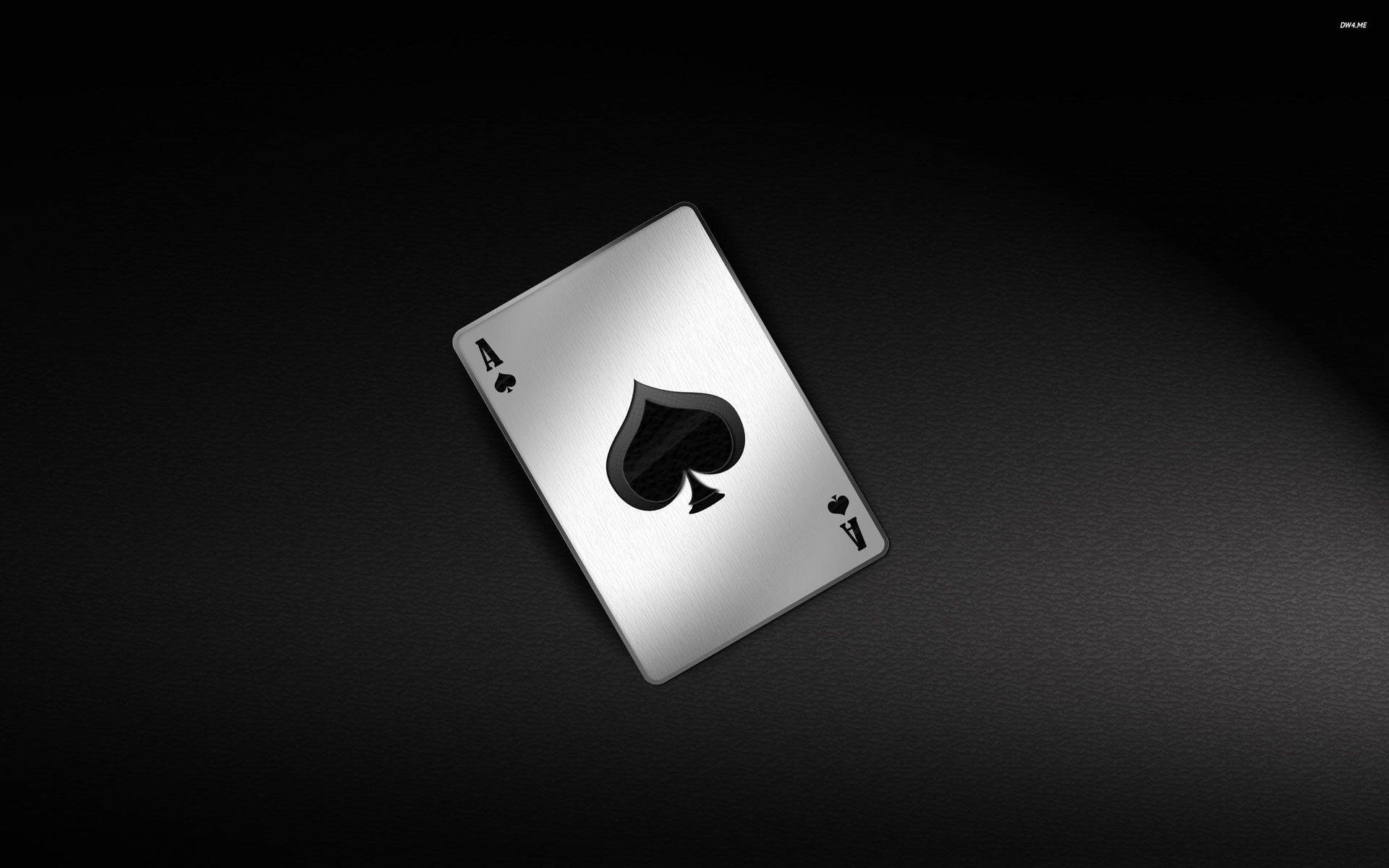 A Black And Silver Playing Card On A Black Background