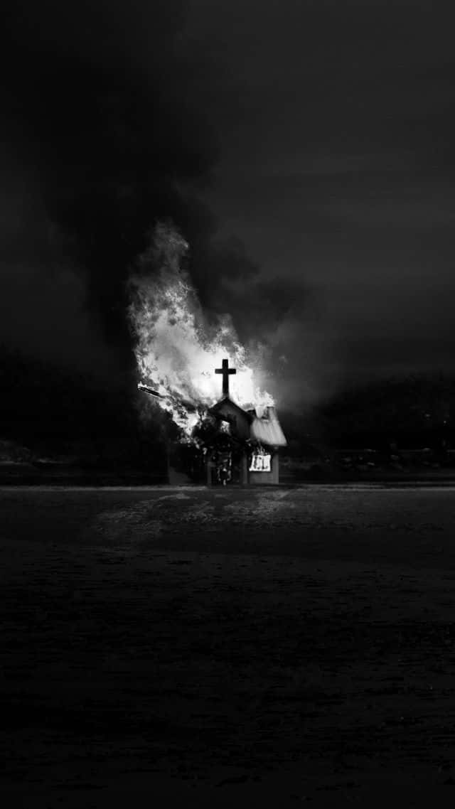 A Black And White Image Of A Church Burning In The Night Background