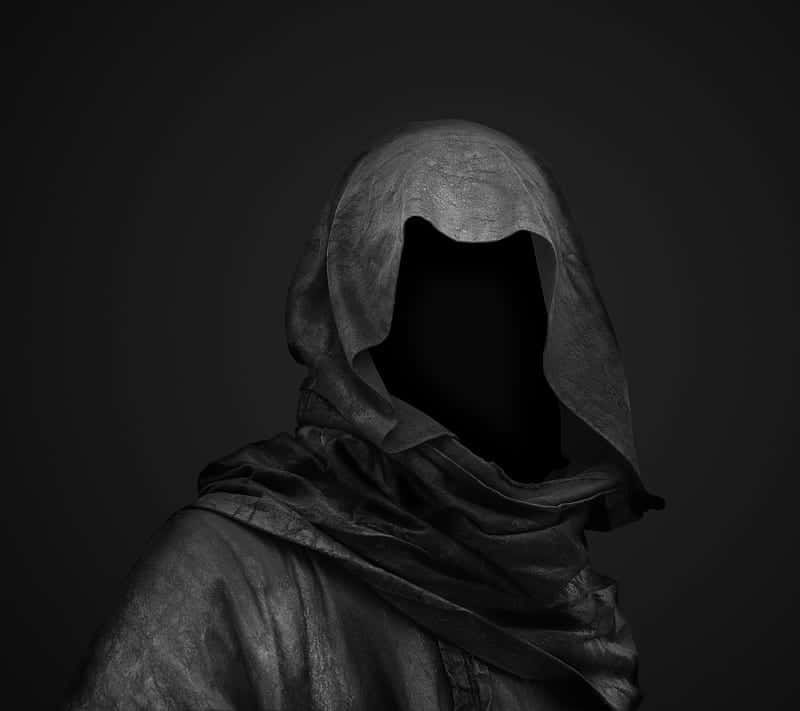 A Black And White Image Of A Man In A Hooded Robe Background